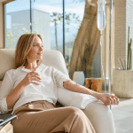 Busy professional relaxing during a vitamin IV drip session at a Palm Springs wellness clinic during back-to-school and fall busy season
